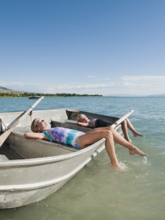 Girls (6-7,8-9) resting on boat.