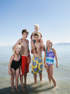 Kids (2-3,6-7,8-9,10-11,12-13) playing in lake.