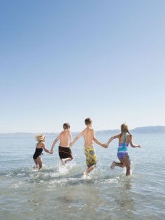 Kids (6-7,8-9,10-11,12-13) playing in lake.