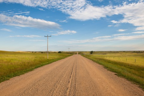 Dirt road crossing prairie.