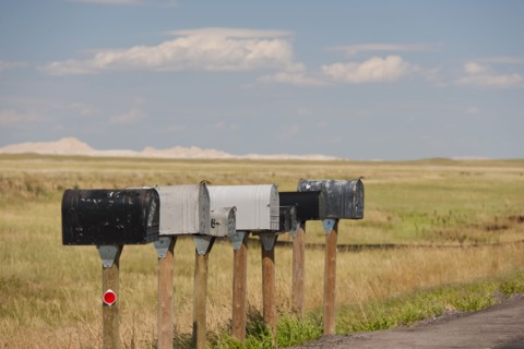 USA, South Dakota, Row of rural mailboxes on roadside in Buffalo Gap National Grasslands.