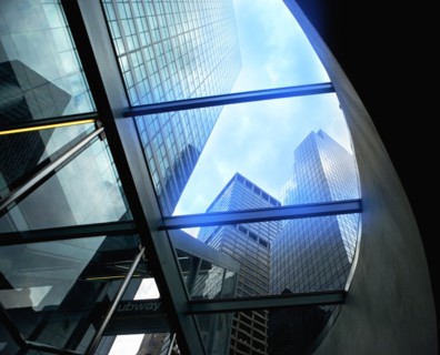 USA, New York State, New York City, Tall skyscrapers seen through glass ceiling of modern office