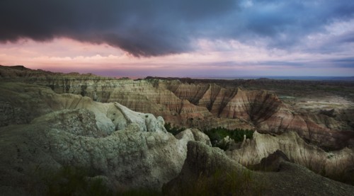 USA, South Dakota, Thick gray clouds over mountains in Badlands National Park.