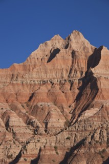 USA, South Dakota, Mountain against blue sky in Badlands National Park.