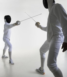 Studio portrait of fighting fencers.