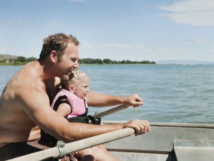 Father and daughter (2-3) on boat.