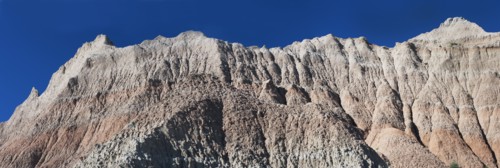 USA, South Dakota, Mountain against blue sky in Badlands National Park.