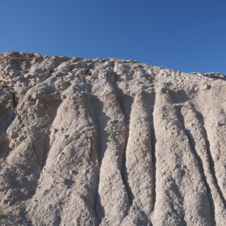 USA, South Dakota, Mountain against blue sky in Badlands National Park.
