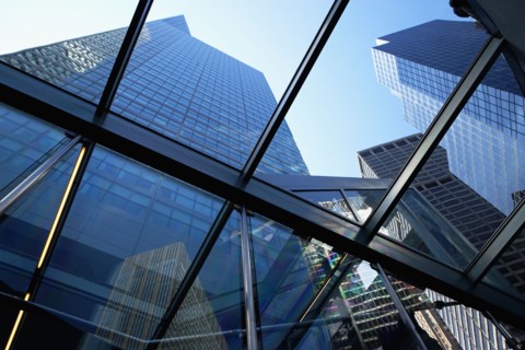 USA, New York State, New York City, Tall skyscrapers seen through glass ceiling of modern office