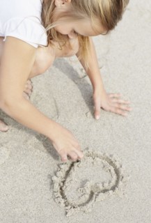 Girl (10-11) playing on beach. Photo : Momentimages