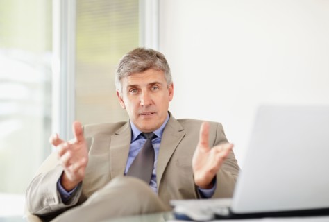 Portrait of cheerful businessman with laptop. Photo : Momentimages
