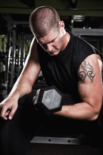 Mid adult man working out in gym. Photo : Take A Pix Media