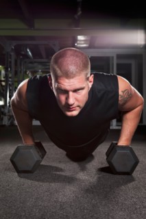 Mid adult man working out in gym. Photo : Take A Pix Media