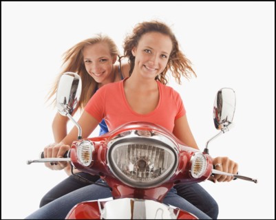 Young girls (16-17) riding scooter. Photo : Mike Kemp