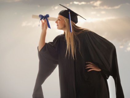 Young girl (16-17) wearing graduating gown. Photo : Mike Kemp