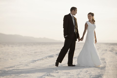 Bride and groom holding hands in desert. Photo : FBP