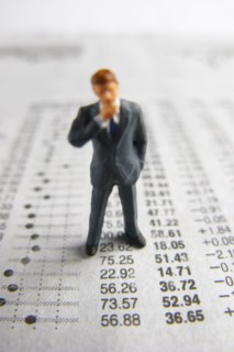Model businessman on financial figures. Photo : Antonio M. Rosario