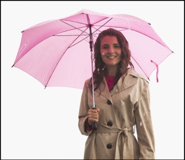 Studio portrait of young woman with umbrella. Photo : Mike Kemp