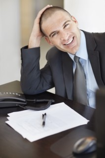 Portrait of cheerful businessman in office environment. Photo : Momentimages