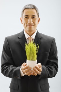 Studio portrait of young man holding wheat grass. Photo : FBP