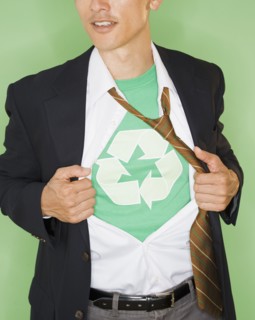 Businessman with wearing t-shirt with recycling symbol under suit, studio shot. Photo : Jamie Grill