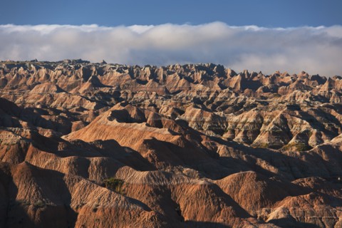 USA, South Dakota, Mountains in morning fog in Badlands National Park.
