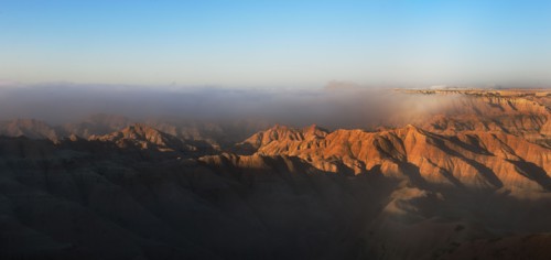 USA, South Dakota, Mountains in morning fog in Badlands National Park.