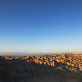 USA, South Dakota, Mountains in morning fog in Badlands National Park.