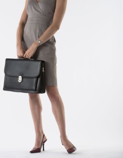 Young woman with briefcase, studio shot.