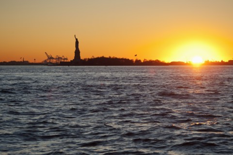 USA, New York City, Staten Island, Harbor and silhouette of Statue of Liberty in background.
