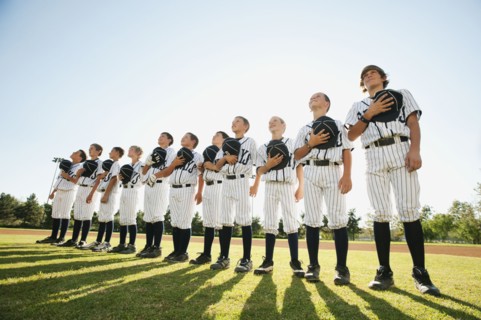 USA, California, Ladera Ranch, little league players (aged 10-11) on field.