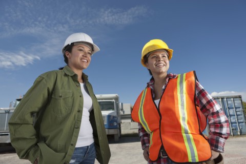 Portrait of two female construction workers on building site. Photo : Dan Bannister
