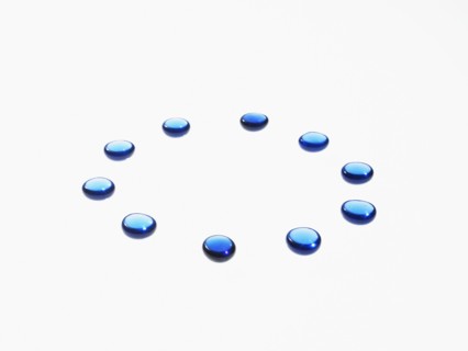 Studio shot of blue glass beads in circle. Photo : David Arky