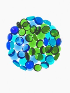 Studio shot of blue and green glass beads in sphere. Photo : David Arky