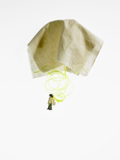 Studio shot of figurine with paper parachute. Photo : David Arky
