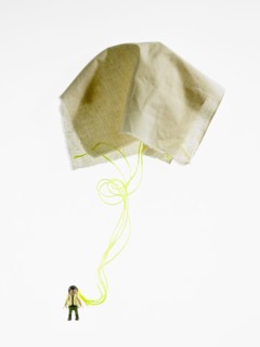 Studio shot of figurine with paper parachute. Photo : David Arky