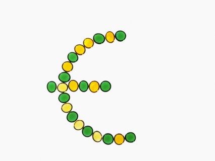 Studio shot of yellow and green glass beads in euro symbol shape. Photo : David Arky