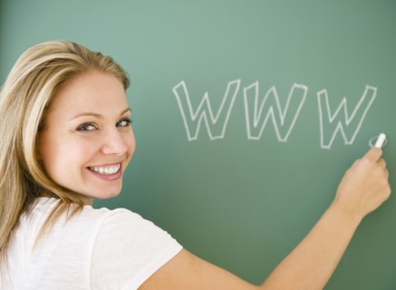 USA, New Jersey, Jersey City, Young attractive woman writing www on blackboard. Photo : Jamie Grill