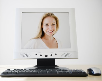 USA, New Jersey, Jersey City, PC flat screen showing attractive young woman. Photo : Jamie Grill