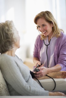 USA, New Jersey, Jersey City, Female nurse checking patients blood pressure.