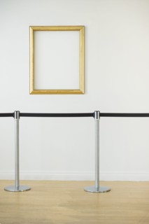Blank picture frame in empty art gallery.