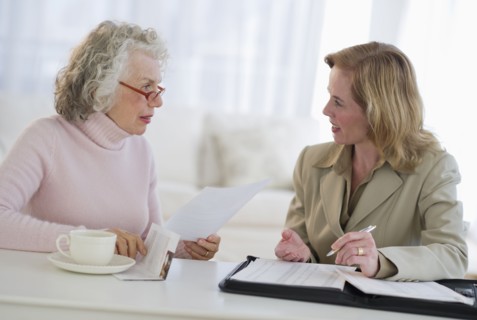 USA, New Jersey, Jersey City, Senior woman talking to financial advisor in home.