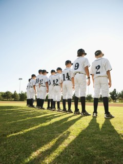 USA, California, Ladera Ranch, little league players (aged 10-11) on field.