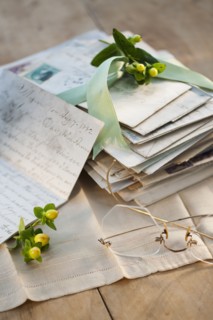 Flowers on pile of letters.