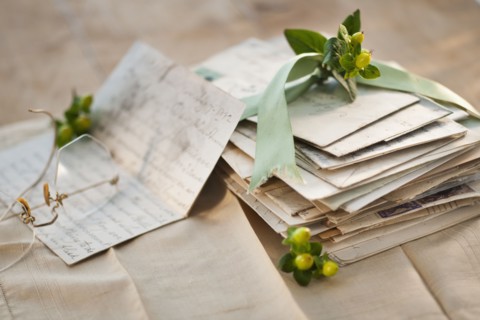 Flowers on pile of letters.