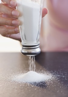 USA, New Jersey, Jersey City, Woman hand holding salt shaker upside down. Photo : Jamie Grill