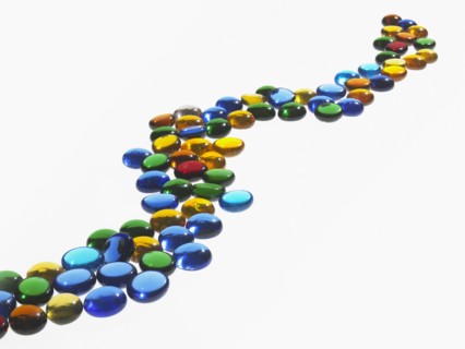 Studio shot of colorful glass beads in row. Photo : David Arky