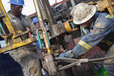 Oil workers drilling for oil on rig. Photo : Dan Bannister