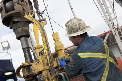 Oil worker drilling for oil on rig. Photo : Dan Bannister