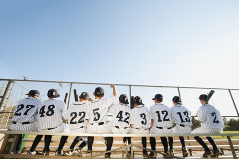 USA, California, Ladera Ranch, Boys (10-11) from little league sitting on bench, rear view.